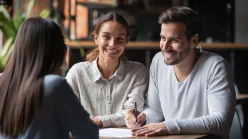 Three people sitting down and talking to each other