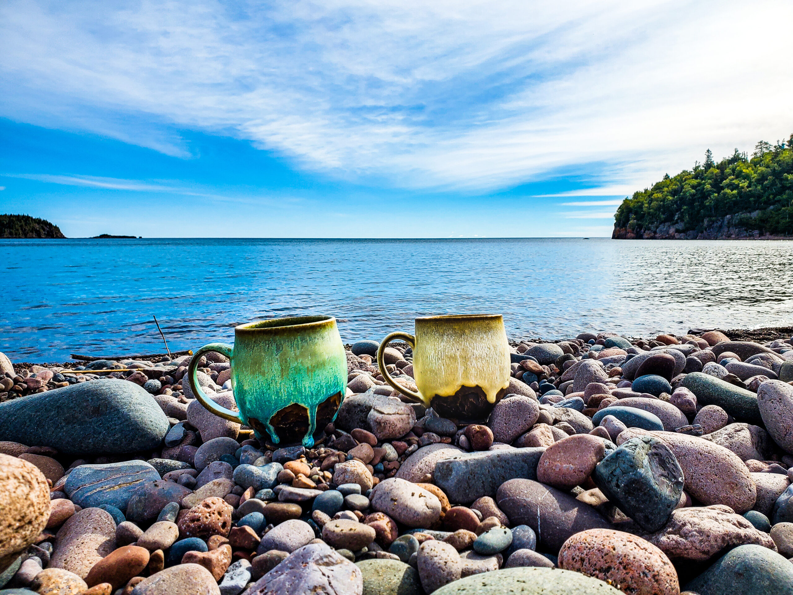 handmade pottery mugs enjoying rocky beach on north shore, Minnesota handmade pottery mugs enjoying rocky beach on north shore, Minnesota
